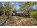 Charming one-story home with white siding, green shutters, and a front porch at 1765 Holly Springs Ne Rd, Marietta, GA 30062