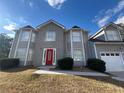 Gray siding, red door, and a three car garage at 3207 Clifton Farm Dr, Decatur, GA 30034