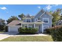 Two-story home with light blue siding and landscaping at 214 Kensington Trce, Stockbridge, GA 30281