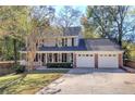 Two-story house with a brick facade, attached two-car garage, and landscaping at 2864 Holly Oaks Dr, Marietta, GA 30062