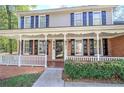 Charming front porch with white railings and brick columns at 2864 Holly Oaks Dr, Marietta, GA 30062