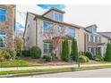 Three-story home with light brick exterior and landscaping at 4204 Hardy Ave, Smyrna, GA 30082