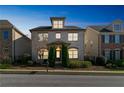 Attractive three-story home with lighted windows at dusk at 4204 Hardy Ave, Smyrna, GA 30082