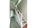 Elegant staircase with white railing and carpeting at 4369 Estate St, South Fulton, GA 30349