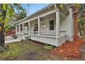 White craftsman home with a long side porch at 5 Ne Broad St, Fairburn, GA 30213