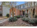 Brick front townhouse with a one-car garage and landscaped yard at 3187 Kingswood Gln, Decatur, GA 30034