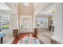 Two-story foyer with hardwood floors, stone columns, and large windows at 1428 Sparkling Cove Dr, Buford, GA 30518