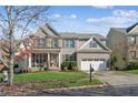 Brick two-story house with a three-car garage and landscaped lawn at 1428 Sparkling Cove Dr, Buford, GA 30518