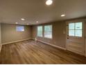 Bright living room with hardwood floors and large windows at 1885 Broad Ave, East Point, GA 30344