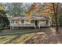 Ranch style home with white porch railings and landscaping at 132 Park E Ave, Dallas, GA 30157