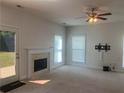 Living room with fireplace, neutral walls, and backyard access at 2118 Water Mill Ct, Buford, GA 30519