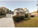 Two-story house with attached garage and manicured landscaping at 340 Bay Grove Rd, Loganville, GA 30052