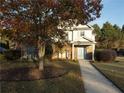Two-story house with brick and siding, featuring a light blue door and landscaping at 340 Bay Grove Rd, Loganville, GA 30052