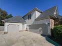 Two-car attached garage with gray doors and concrete driveway at 340 Bay Grove Rd, Loganville, GA 30052