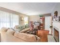 Living room with hardwood floors, sectional sofa, and fireplace at 1778 Campbellton Sw Rd, Atlanta, GA 30311