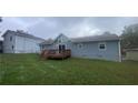 Gray house with wooden deck and fenced yard at 2073 Marbut Ln, Lithonia, GA 30058