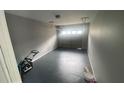 Attached garage with painted floor and overhead door at 2073 Marbut Ln, Lithonia, GA 30058