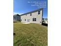 Rear view of a two-story house with a patio and grassy yard at 4240 Oakhurst Dr, Fairburn, GA 30213