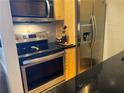 Modern kitchen with stainless steel appliances and granite countertops at 98 De Arc Nw, Atlanta, GA 30327