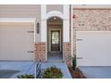 Front entrance with a brick walkway leading to a dark-stained door at 701 Trevett Way, Marietta, GA 30062