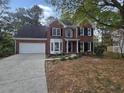 Brick two-story house with a large front yard and stamped concrete driveway at 2654 Calumet Farm Ln, Snellville, GA 30039