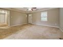 Living room with carpet, ceiling fan and access to hallway at 1187 Dixie Rd, Covington, GA 30014