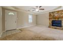 Living room featuring a stone fireplace and carpet flooring at 1187 Dixie Rd, Covington, GA 30014