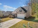 Two-story house with a spacious driveway and a neatly landscaped yard at 117 Prescott Dr, Canton, GA 30114