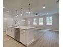 Modern kitchen with white cabinets, center island, stainless steel appliances, and hardwood floors at 135 Bluffington Way, Marietta, GA 30066