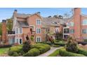 Brick front of charming townhome with manicured landscaping and walkway at 5356 Brooke Ridge Dr, Dunwoody, GA 30338