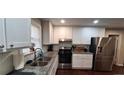 Modern kitchen with white cabinets, granite counters at 2756 Gresham Se Rd, Atlanta, GA 30316