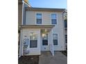 Two-story beige townhome with white trim and landscaping at 6500 Wellington Chase Ct, Lithonia, GA 30058