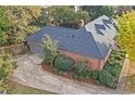 Brick home with attached garage and a curved driveway at 2545 Winthrope Way, Lawrenceville, GA 30044