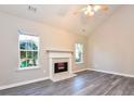 Bright living room features a fireplace, hardwood floors, and neutral walls at 6315 Wellington Walk Way, Lithonia, GA 30058