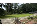 Large grassy yard with driveway and mature trees at 539 Lynhurst Sw Dr, Atlanta, GA 30311