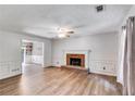 Bright living room featuring a brick fireplace and laminate wood flooring at 4558 Dorsett Shoals Ct, Douglasville, GA 30135