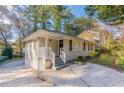 Front view of a charming ranch home with a white railing and spacious driveway at 2301 Delowe Dr, Atlanta, GA 30344