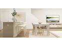 Bright dining area with white table and gold chairs adjacent to kitchen island at 212 Kenoot Dr, Mcdonough, GA 30253