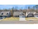 Three-story homes in a neighborhood setting with lush green lawns at 63 Black Rock Rdg, Sharpsburg, GA 30277