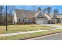 Two-story house with gray siding, stone accents, and a three-car garage at 63 Black Rock Rdg, Sharpsburg, GA 30277
