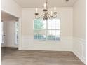 Bright dining room featuring hardwood floors and a chandelier at 4815 Candy Cv, Lithonia, GA 30038