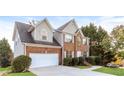 Two-story brick home with a white garage door and manicured lawn at 4815 Candy Cv, Lithonia, GA 30038