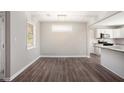 Simple dining area with dark wood-look floors and view into kitchen at 3015 Flat Shoals Rd, Atlanta, GA 30349
