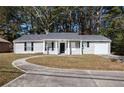 Gray sided ranch home with a curved driveway and attached garage at 3015 Flat Shoals Rd, Atlanta, GA 30349