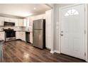 Modern kitchen with stainless steel appliances and dark wood-look floors at 3015 Flat Shoals Rd, Atlanta, GA 30349