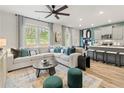 Spacious living room with L-shaped sofa, large windows, and a modern coffee table at 400 Brooch Way, Stockbridge, GA 30281