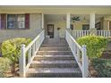 Brick steps leading to a porch with white railings at 3520 Tom Brewer Rd, Loganville, GA 30052