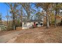 House nestled in wooded area with a long driveway at 3060 Wilkes Plantation Way, Douglasville, GA 30135