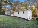 Side view of a brick ranch home with a grassy yard at 3811 Paul St, Douglasville, GA 30135