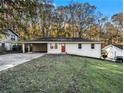 Brick ranch home with a red door and attached carport at 3811 Paul St, Douglasville, GA 30135